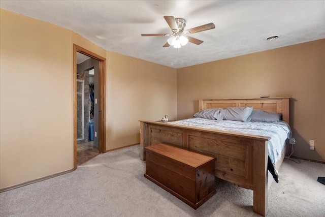 bedroom featuring visible vents, light colored carpet, baseboards, and ceiling fan