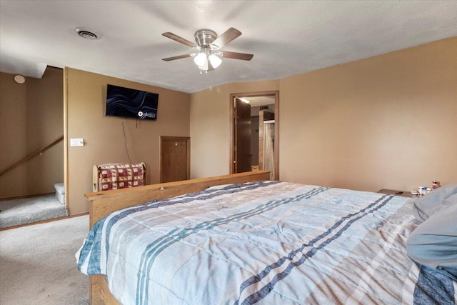 bedroom with visible vents, carpet flooring, and a ceiling fan