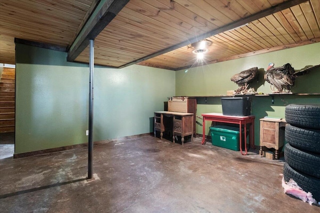 finished basement featuring baseboards and wood ceiling