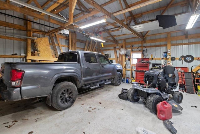 garage featuring a garage door opener and metal wall