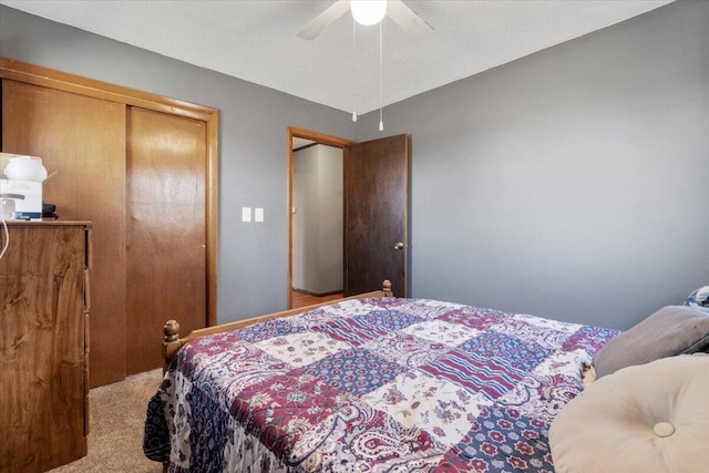 carpeted bedroom with a closet and ceiling fan