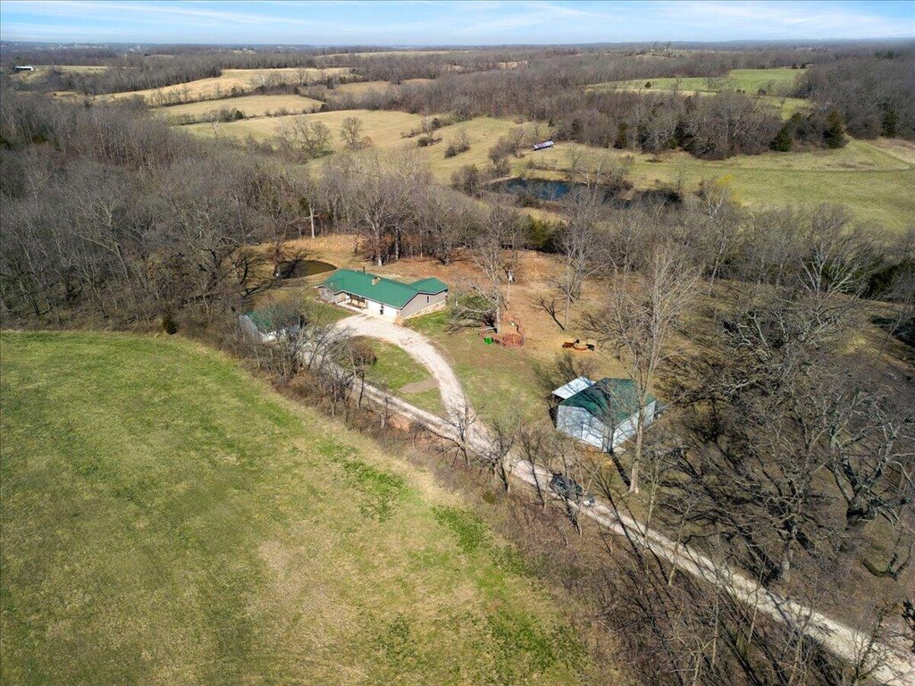 birds eye view of property with a rural view