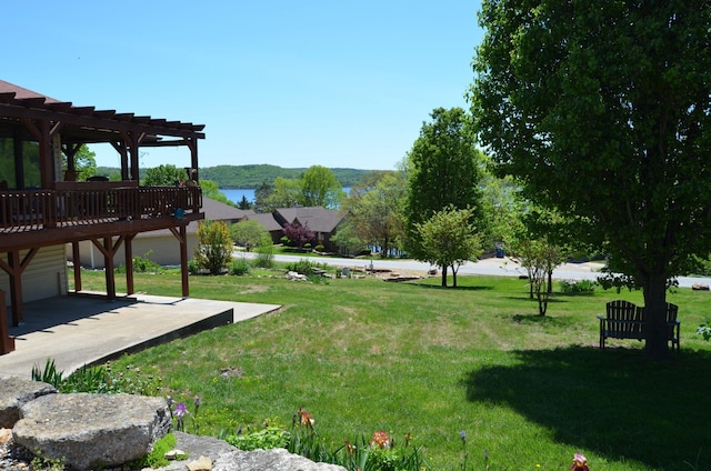 view of yard with a pergola, a patio area, and a wooden deck