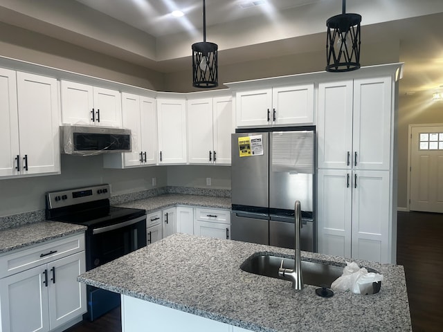 kitchen featuring light stone countertops, dark wood finished floors, white cabinets, stainless steel appliances, and a sink