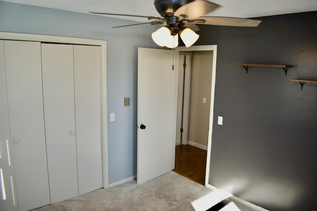 unfurnished bedroom with a closet, carpet, and ceiling fan