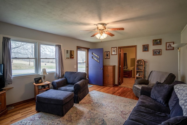 2457 County Road 1770, West Plains, MO 65775 - living area with a ceiling fan, wood finished floors, and baseboards