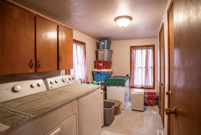 2457 County Road 1770, West Plains, MO 65775 - laundry area featuring visible vents, plenty of natural light, cabinet space, and independent washer and dryer