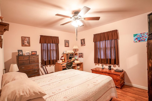 2457 County Road 1770, West Plains, MO 65775 - bedroom featuring a ceiling fan, light wood-style flooring, and baseboards