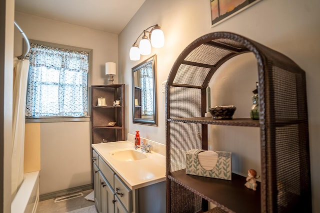 2457 County Road 1770, West Plains, MO 65775 - bathroom with shower / tub combo, visible vents, vanity, and baseboards