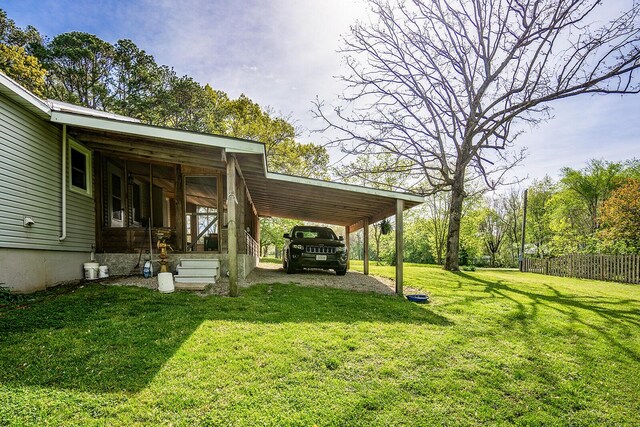 2457 County Road 1770, West Plains, MO 65775 - view of yard featuring driveway, an attached carport, and fence