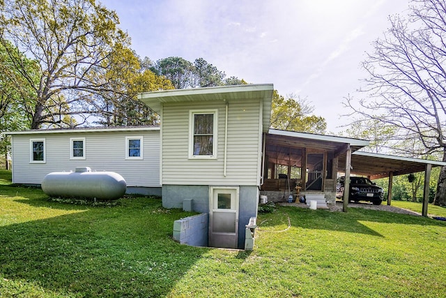 2457 County Road 1770, West Plains, MO 65775 - back of property featuring a lawn and an attached carport