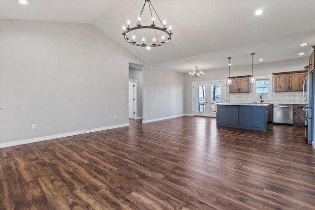 unfurnished living room with dark wood-style floors, baseboards, lofted ceiling, a sink, and a chandelier