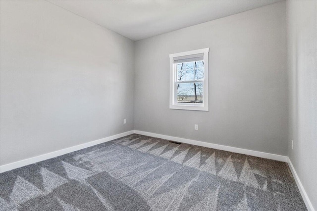 unfurnished room featuring visible vents, baseboards, and carpet floors