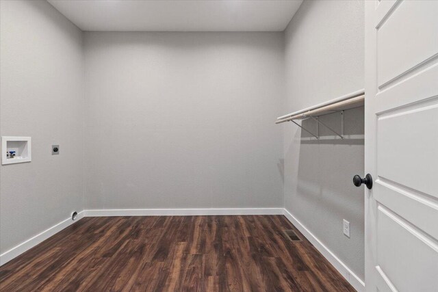 clothes washing area featuring dark wood-type flooring, hookup for an electric dryer, washer hookup, and laundry area