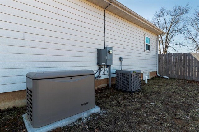 view of side of property featuring central AC and fence