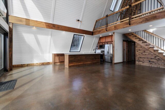84 County Road 104, Gainesville, MO 65655 - interior space with high vaulted ceiling, stairs, and concrete floors