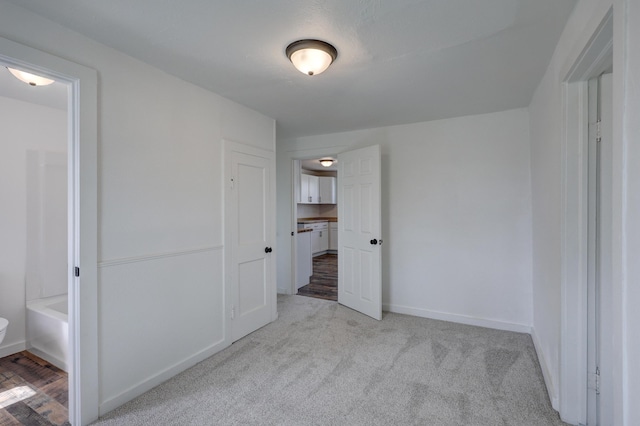 unfurnished bedroom with carpet and baseboards