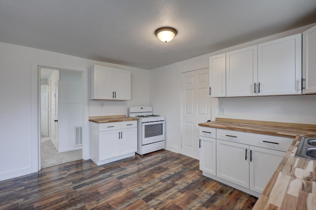 kitchen with visible vents, white cabinets, butcher block counters, and white range with gas stovetop