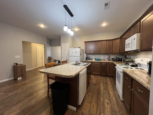 610 N Center St, Willow Springs, MO 65793 - kitchen featuring dark wood finished floors, white appliances, a kitchen island with sink, and a sink