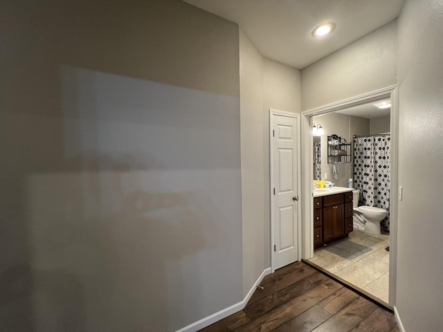 610 N Center St, Willow Springs, MO 65793 - full bathroom featuring vanity, a shower with shower curtain, wood finished floors, baseboards, and toilet