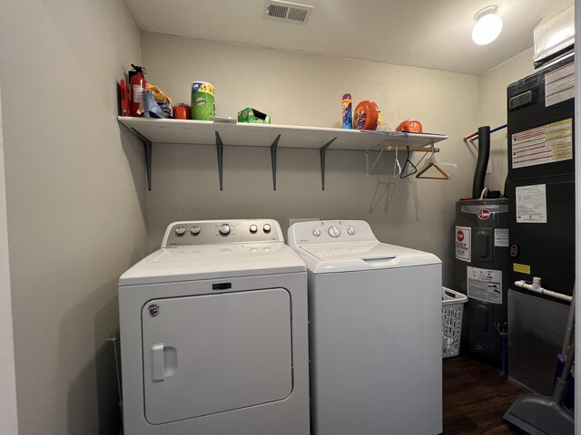 610 N Center St, Willow Springs, MO 65793 - clothes washing area with visible vents, washing machine and clothes dryer, dark wood finished floors, laundry area, and electric water heater
