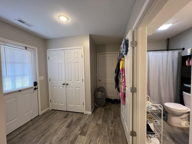610 N Center St, Willow Springs, MO 65793 - full bathroom with visible vents, curtained shower, baseboards, toilet, and wood finished floors