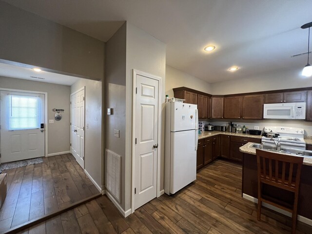 610 N Center St, Willow Springs, MO 65793 - kitchen with visible vents, dark wood-type flooring, white appliances, baseboards, and dark brown cabinets