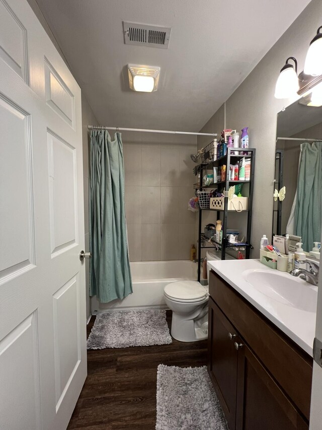 610 N Center St, Willow Springs, MO 65793 - full bath with visible vents, toilet, wood finished floors, vanity, and shower / bathtub combination with curtain