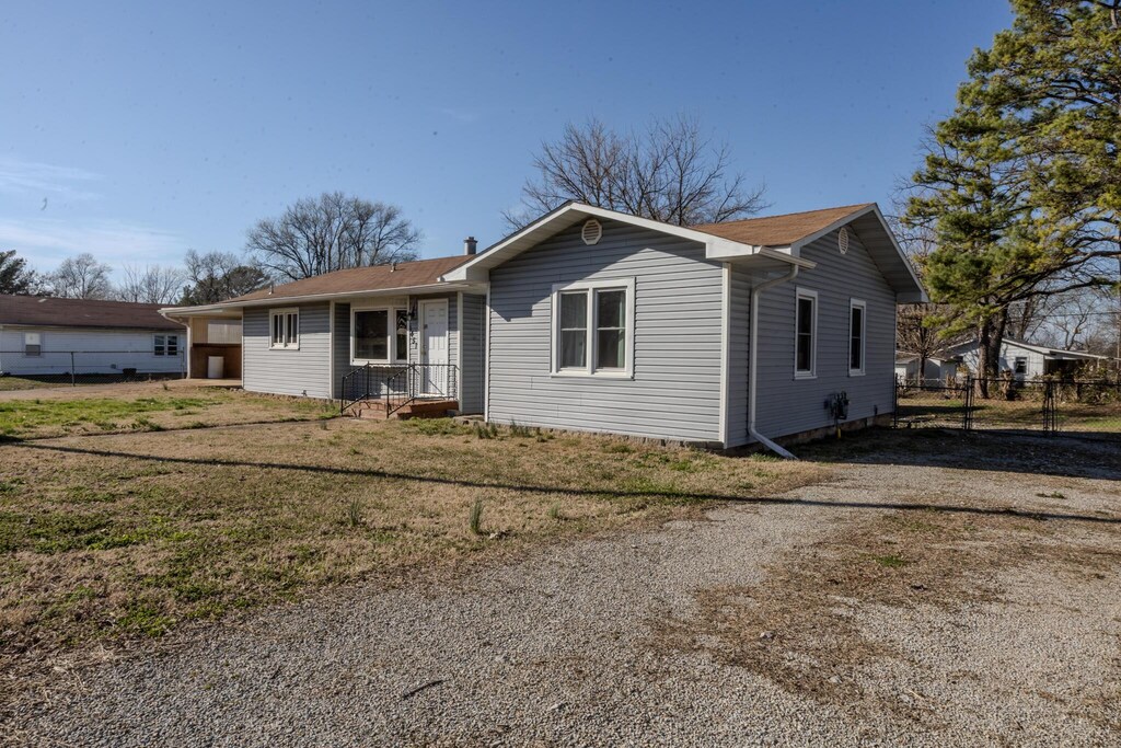 1451 W 5th St, West Plains, MO 65775 - ranch-style home with a front yard and fence