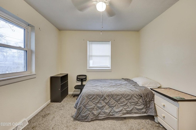 carpeted bedroom with baseboards and ceiling fan