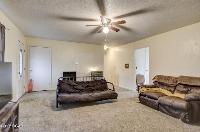 carpeted living room with baseboards, a textured ceiling, and a ceiling fan