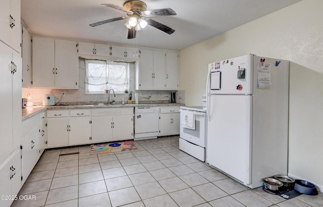 kitchen with light countertops, white appliances, white cabinetry, a ceiling fan, and a sink