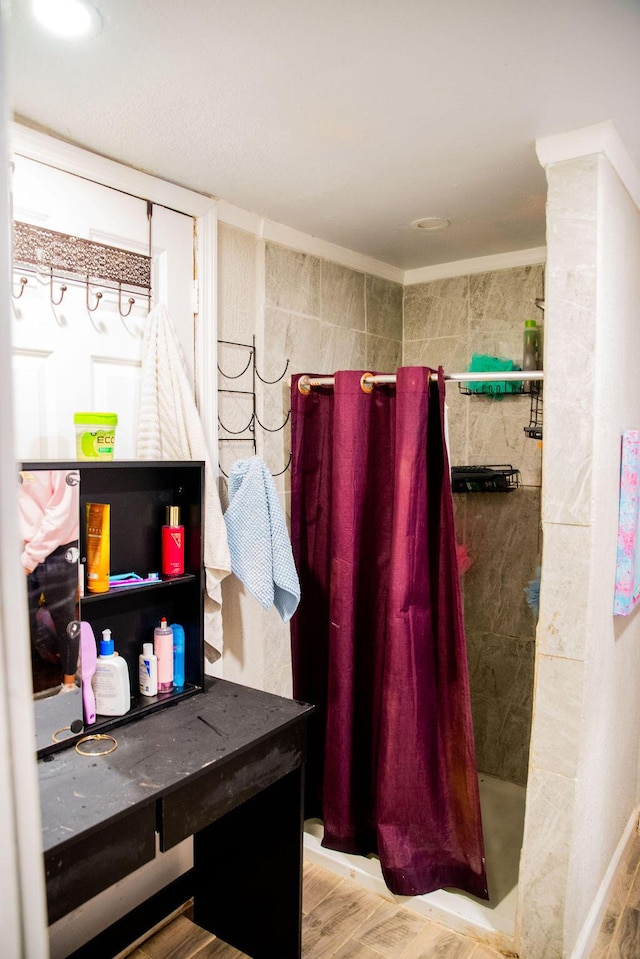 full bath featuring wood finished floors and a shower stall