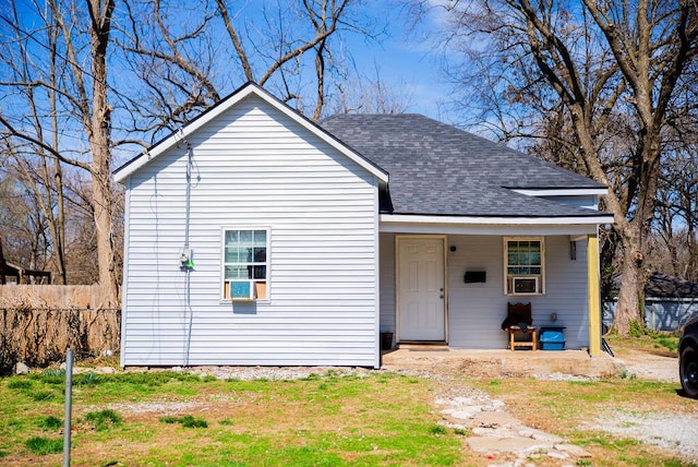 bungalow featuring fence and a shingled roof