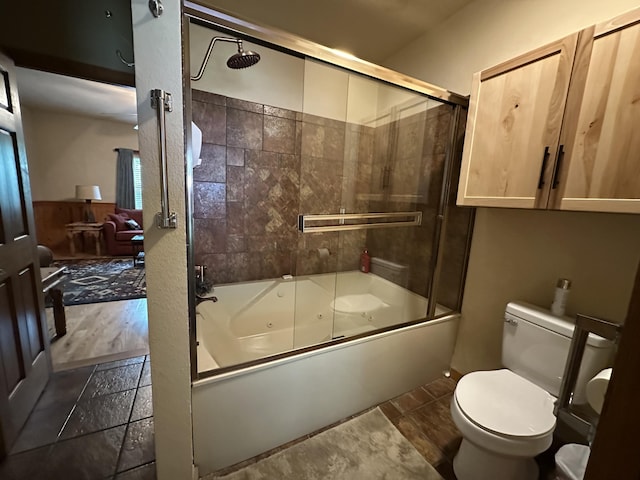 215 Oakridge Rd, Branson, MO 65616 - bathroom featuring bath / shower combo with glass door, toilet, and stone tile floors