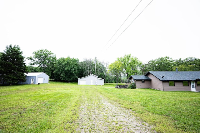 1618/1620 Tt, Bolivar, MO 65613 - view of grassy yard with an outbuilding, a detached garage, and view of scattered trees