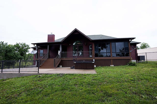 1618/1620 Tt, Bolivar, MO 65613 - view of front of house featuring a hot tub, a chimney, a patio, and a sunroom