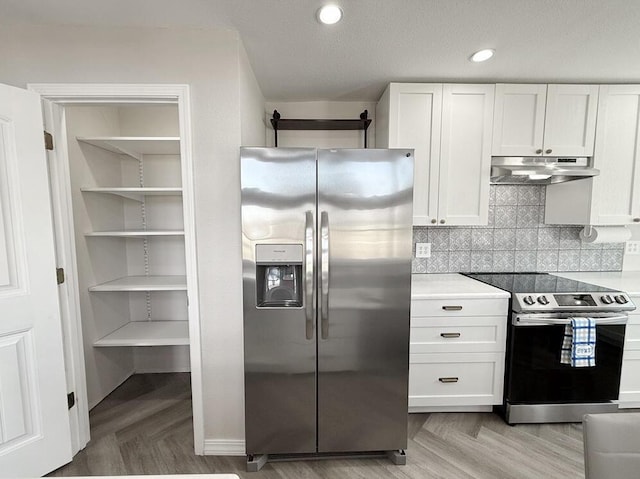 3100 E 354th Rd, El Dorado Springs, MO 64744 - kitchen featuring stainless steel appliances, under cabinet range hood, white cabinets, light countertops, and recessed lighting