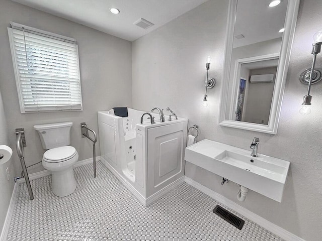 3100 E 354th Rd, El Dorado Springs, MO 64744 - bathroom with a jetted tub, toilet, baseboards, recessed lighting, and a wall unit AC