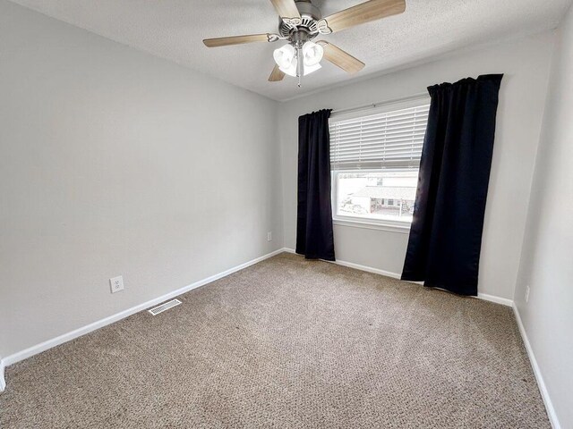 3100 E 354th Rd, El Dorado Springs, MO 64744 - empty room featuring carpet flooring, a textured ceiling, and baseboards