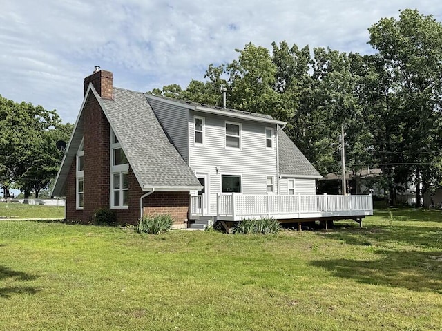 3100 E 354th Rd, El Dorado Springs, MO 64744 - back of property with roof with shingles, a chimney, a lawn, a deck, and brick siding