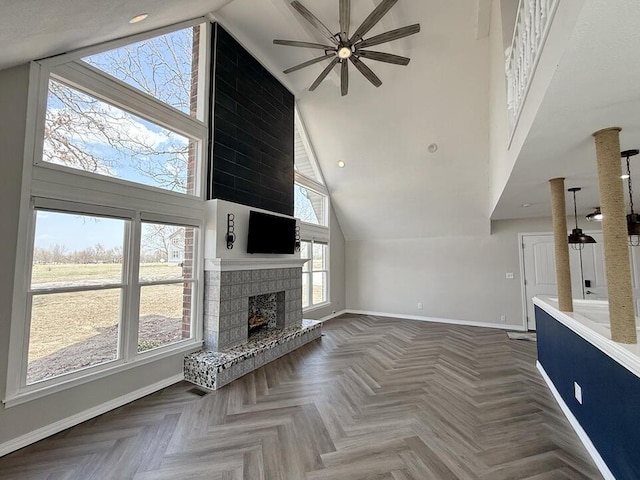 3100 E 354th Rd, El Dorado Springs, MO 64744 - unfurnished living room with baseboards, ceiling fan, high vaulted ceiling, and a fireplace with raised hearth