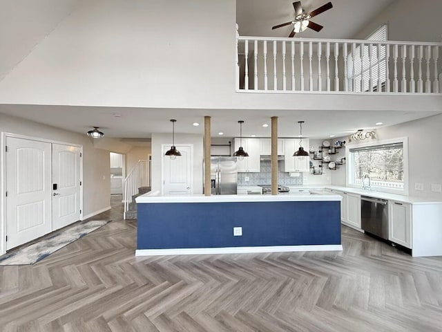 3100 E 354th Rd, El Dorado Springs, MO 64744 - kitchen featuring appliances with stainless steel finishes, ceiling fan, a high ceiling, white cabinets, and light countertops