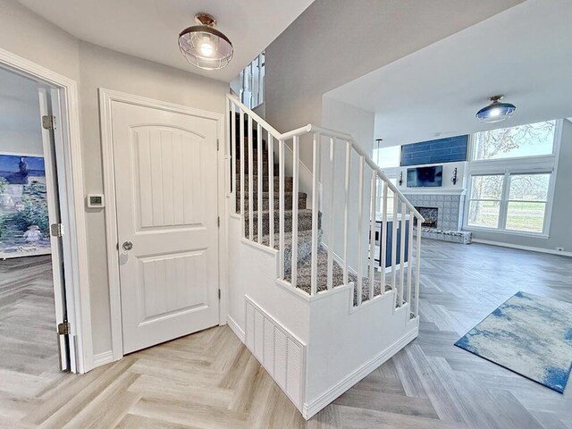 3100 E 354th Rd, El Dorado Springs, MO 64744 - stairs featuring a fireplace and baseboards