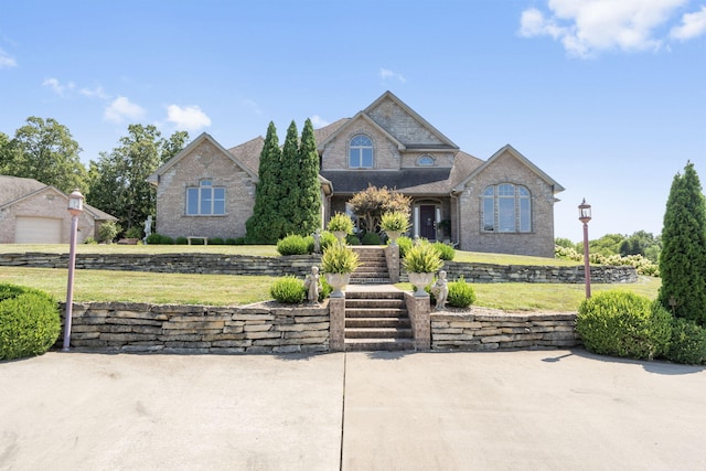 view of front facade with brick siding and a front yard