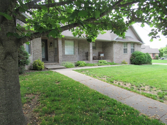 640 S Shuyler St, Republic, MO 65738 - view of front of house with a front yard, brick siding, and roof with shingles