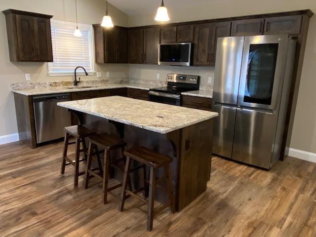 2520 S Schifferdecker Ave, Joplin, MO 64804 - kitchen with a kitchen island, dark brown cabinets, stainless steel appliances, and a sink