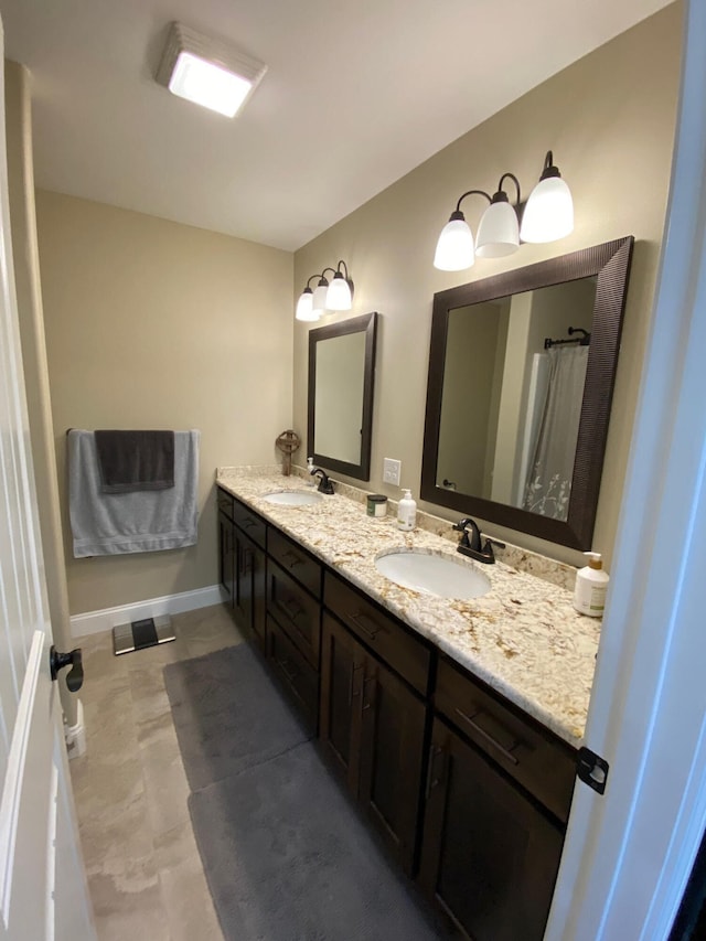 2520 S Schifferdecker Ave, Joplin, MO 64804 - bathroom with double vanity, baseboards, and a sink