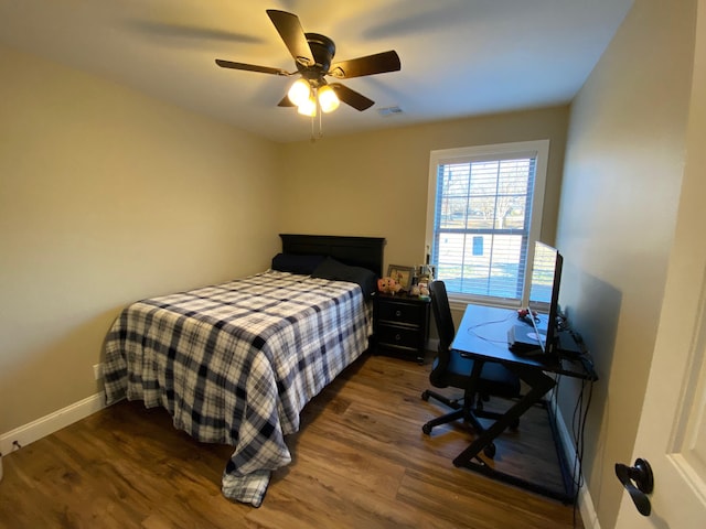 2520 S Schifferdecker Ave, Joplin, MO 64804 - bedroom featuring a ceiling fan, dark wood-type flooring, and baseboards