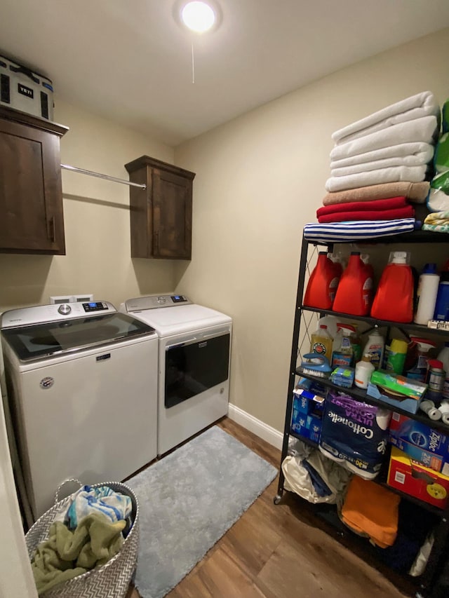 2520 S Schifferdecker Ave, Joplin, MO 64804 - laundry room featuring wood finished floors, cabinet space, baseboards, and washing machine and clothes dryer